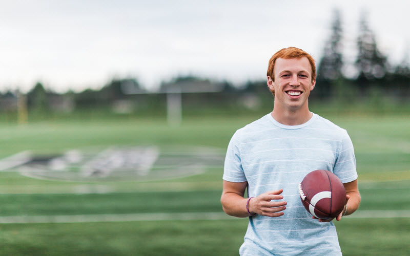 Young man holding football