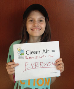 teen girl holding sign, sign reads What Clean Air Means to Me