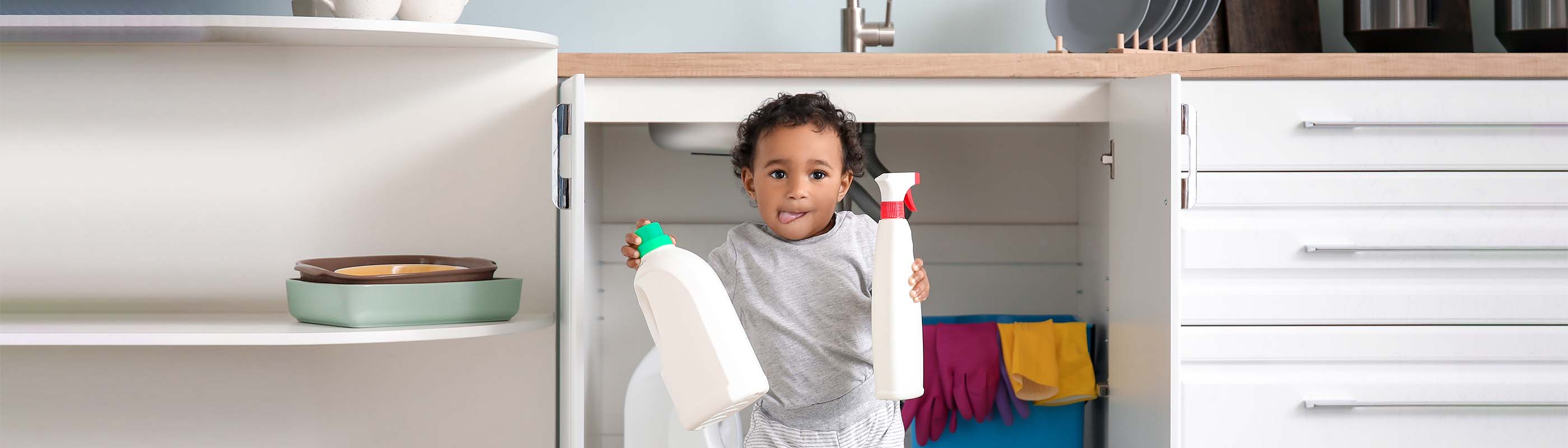 Child with cleaning bottles